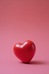 Fototapeta premium Red heart on pink background - symbol of love and romance