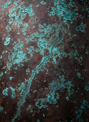 Fototapeta premium Macro Shot of Aged Copper Surface with Rich Green Verdigris Patina and Rusty Brown Oxidation Texture, Abstract Industrial Grunge Background for Design Projects.