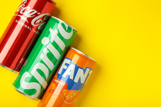 Mykolaiv, Ukraine - March 25, 2026: Iron cans of Coca Cola, Fanta and Sprite drink on yellow background.