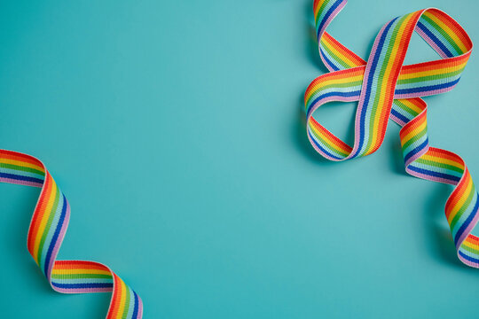 Autism acceptance month, Autism awareness day background with rainbow ribbon and infinity on blue background