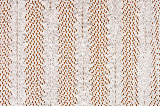 Light beige openwork knitted pattern airy lace style textile background