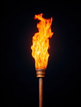 A bright orange flame burns atop a rustic torch against a pitch-black background, creating a striking and dramatic contrast.