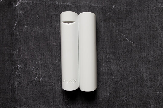 Ukraine, Dnipro, March 28, 2026 - Ajax home alarm sensor on a black