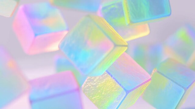 Slow motion tracking shot of iridescent cubes floating and rotating in pastel studio with soft gradient background