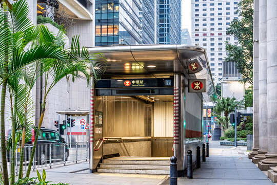 Hong Kong, China, 27 February 2026: entrance of Central Station metro with MTR signage surrounded by modern buildings and urban greenery in the financial district