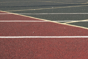 Fototapeta premium Sport floor. Interior of empty modern indoor sport court, coating Crumb rubber flooring, artificial. Sports surface with different marking lines. Recycled rubber Athletic field. Run track markup. 4K