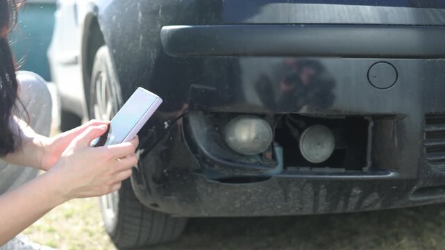 close up of the mechanic's hands, who removes the bumper of the car, he repairs the car.