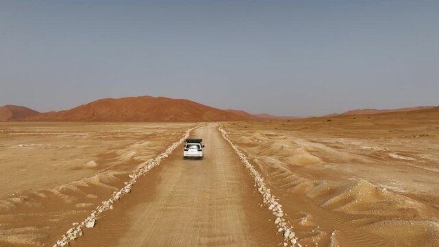 Vehicle drives through sand dunes of Empty Quarter, Rub al-Chali in Oman