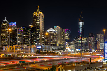 Fototapeta premium Atlanta Night Skyline with Light Trails on Highway and Illuminated Midtown Towers