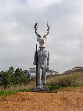 Beautiful sculpture Veado Surfista, Deer-Man-Surfer with surf board at Praia do Norte in Nazar&eacute;, by sculptor Ad&aacute;lia Alberto. Silver Coast is popular surf route in Europe. Nazare, Portugal.