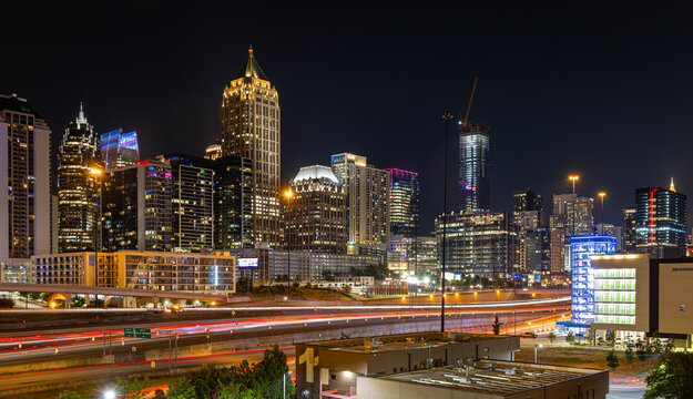 Atlanta Night Skyline with Light Trails on Highway and Illuminated Midtown Towers