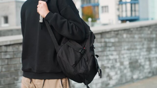 Bold man walks lively. Confident man in casual attire explores urban landscape energetically. An assured person dressed informally navigates bustling metropolitan environment with lively enthusiasm