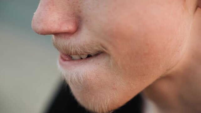 Side profile closeup white male biting lip, tongue flick and nervous smile, freckles and fine stubble, soft bokeh pier background, evening light, actor rehearsing lines, palpable anticipation