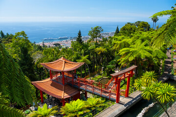 Obraz premium Monte Palace tropical garden with red pagoda, lakes and traditional buildings above the city of Funchal, popular tourist destination in Madeira island, Portugal