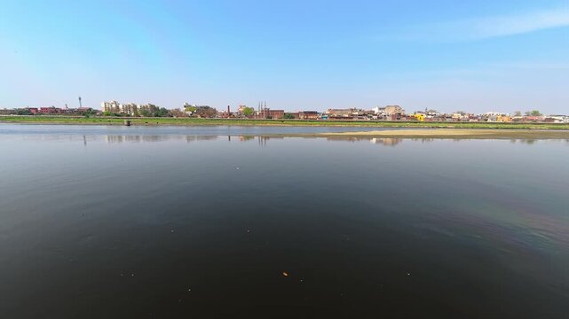 Indian jamuna scenic view of a river with a cityscape on the horizon 4k stock video footage.