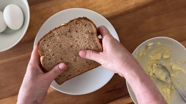 Eating a Egg Salad Sandwich on Wheat Bread