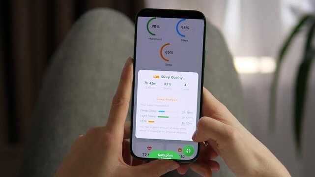 User interacting with a smartphone displaying advanced sleep analysis and fitness metrics. Clean UI design showing movement and step goals. Ideal for tech, healthcare, self-improvement, and mobile