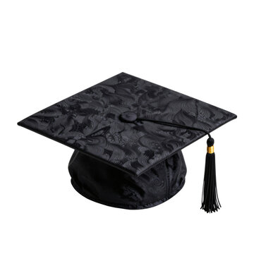 Black graduation cap with a tassel lies on a white surface in a studio setting