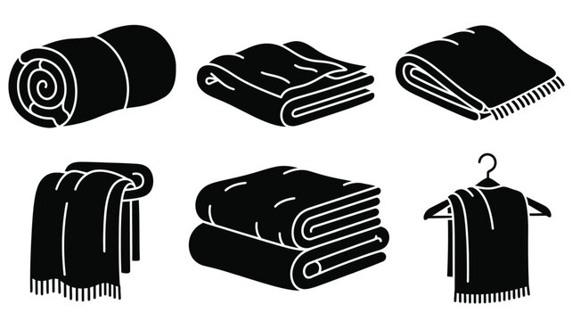 Folded towels and rolled blankets presented in a dark silhouette