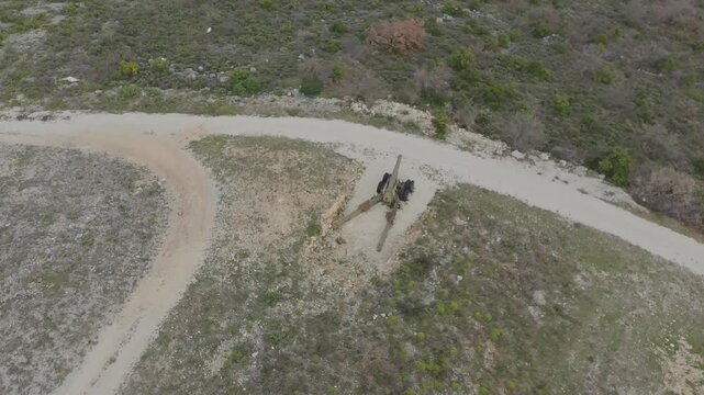 Aerial drone video of a howitzer artillery gun on the firing position