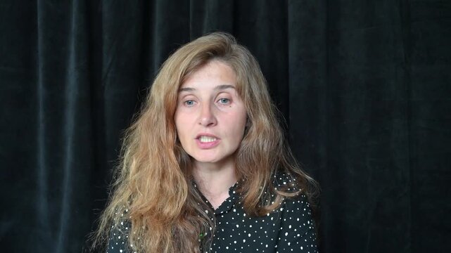 Portrait of a girl with long hair on a black background,