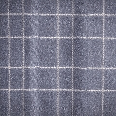 Fototapeta premium Fabric with grid pattern in blue and white on display at a textile market during afternoon hours