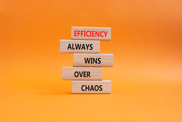 Obraz premium Efficiency symbol. Wooden blocks with words Efficiency Always Wins Over Chaos. Beautiful orange background. Businessman hand. Business and Efficiency concept. Copy space