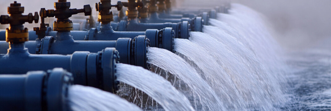 Pipes release water at oil and gas well site in daytime Generative AI