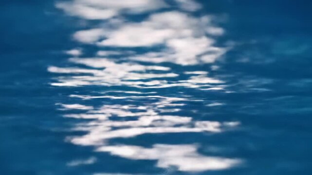 Extreme macro deep sapphire blue water surface, subtle rhythmic undulations, shimmering ethereal highlights, ultra-smooth tracking zoom, minimalist shallow DOF, concept of effortless fluid data flow