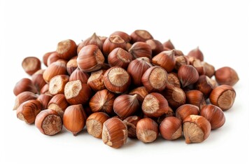 Fototapeta premium Hazelnuts are piled, creating a small mountain of nuts on a clean white background