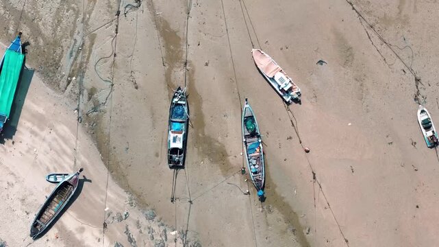 Top down aerial turquoise sea water texture and fishing boats on dock in Phuket Thailand