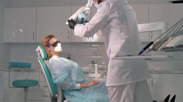 A young blonde lies in a chair at the dentist's appointment