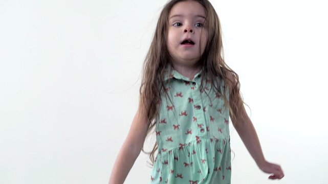 Beautiful cute baby laughing and jumping on the couch against a white background. Slow motion 