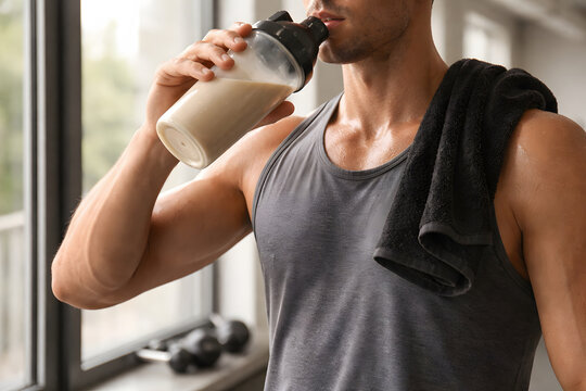 Male athlete drinks a protein shake after training to support recovery muscle growth and a bulking nutrition plan