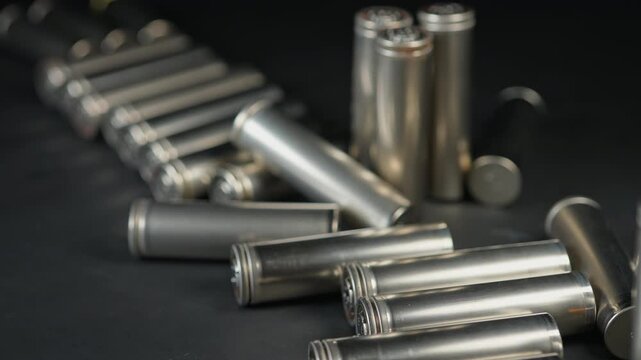 Silver AA batteries type on black matte background as an example of rare earths metals use in magnets, smart devices, electric vehicles and are hard to mine and separate cleanly.