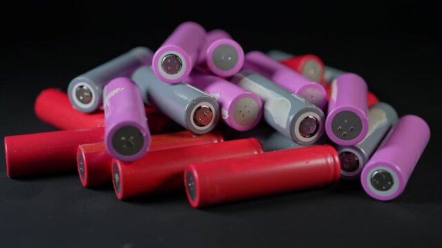 Battery cells extracted from inside assembly of high tech modules. Such as EV electric vehicles, electric e-bikes and computers cordless power parts. Energy storage and tech power.