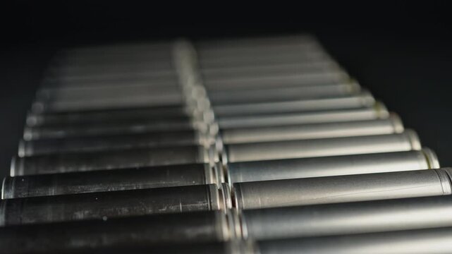 Silver AA batteries type on black matte background. Standard size single cell cylindrical dry battery for EV vehicles and portable electronic devices such as computers and laptop cordless power.