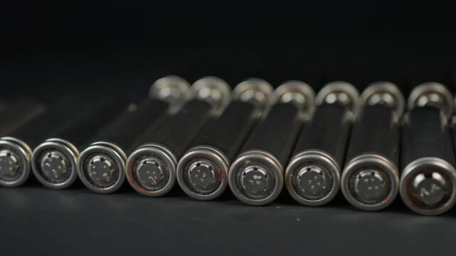 Silver AA batteries type on black matte background as an example of rare earths metals use in magnets, smart devices, electric vehicles and are hard to mine and separate cleanly.