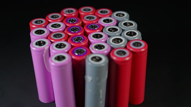 Silver AA batteries type on black matte background as an example of rare earths metals use in magnets, smart devices, electric vehicles and are hard to mine and separate cleanly.