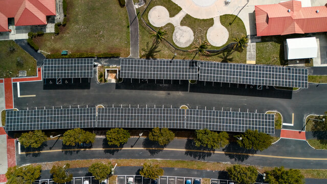 Drone view of covered parking with solar panels in Lauderhill Florida