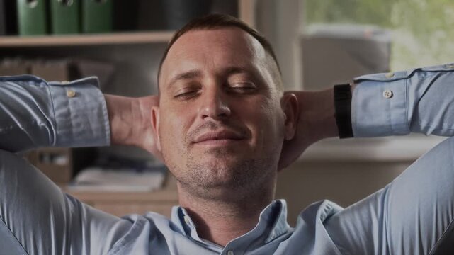 Portrait of a manager in the office with closed eyes smiling and dreaming of a vacation 