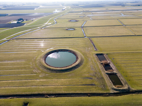 Aerial view of a traditional circular water reservoir or Dobbe water pond in Friesland, The Netherlands