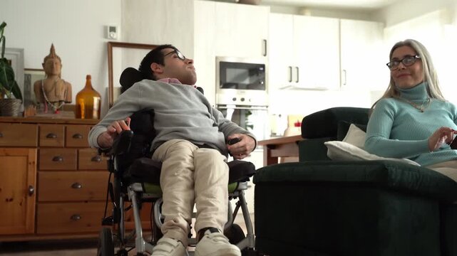 Disabled man in electric wheelchair spending time with mother
