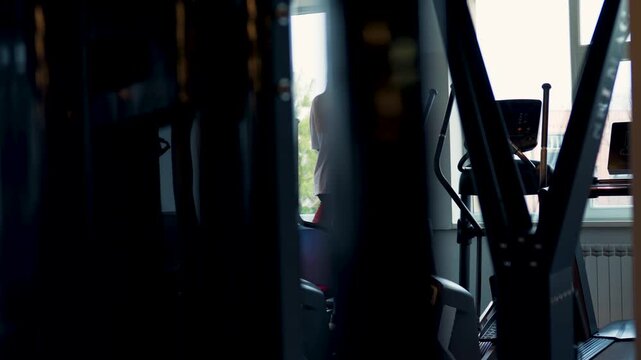 Woman Training on Treadmill in Gym Back View Cardio Workout