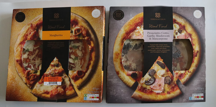 March 28 2026, Norwich, England, UK: Editorial photos taken today in Norwich. Appetizing italian pizza boxes highlighting classic and cheese varieties in warm lighting