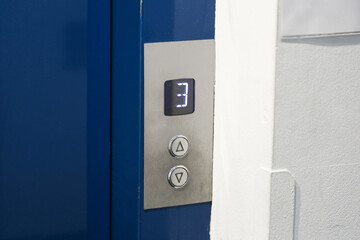 Elevator control panel with buttons and floor indicator. Modern lift system detail inside building interior. Clean close view of metal panel with illuminated display for vertical transport, © Paweł Michałowski