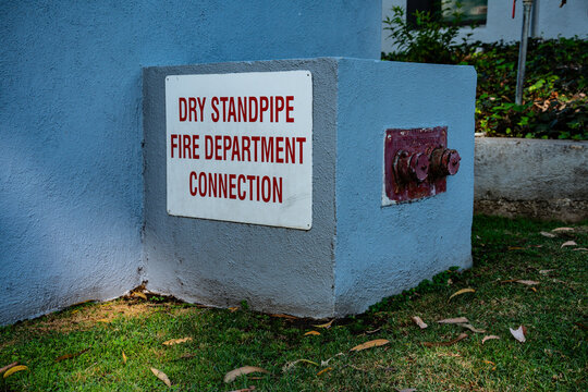 Dry standpipe fire department connection on a building exterior