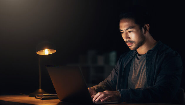 Startup founder working late night on laptop