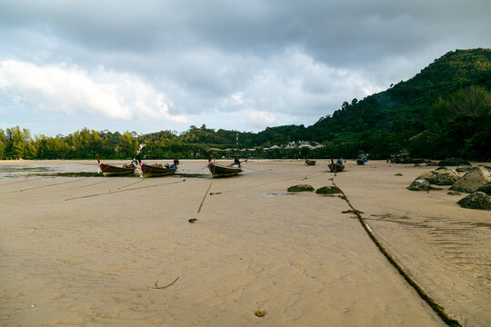 Boats anchored on sandy shore at Nai Yang Beach Phuket Thailand