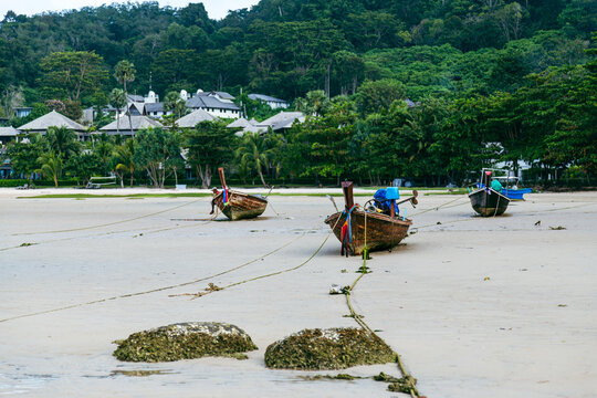 Long tail boats on sandy beach at Nai Yang Beach Phuket Thailand